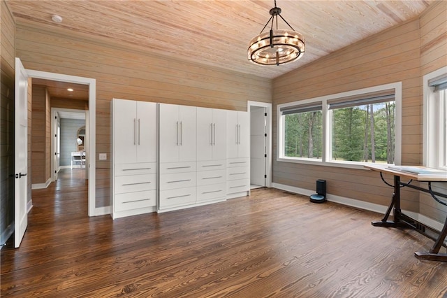 interior space with vaulted ceiling, wood-type flooring, an inviting chandelier, wooden ceiling, and wood walls