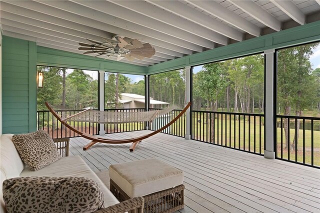 sunroom with beamed ceiling, plenty of natural light, and ceiling fan