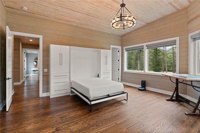 bedroom with vaulted ceiling, wooden walls, wooden ceiling, a chandelier, and hardwood / wood-style floors