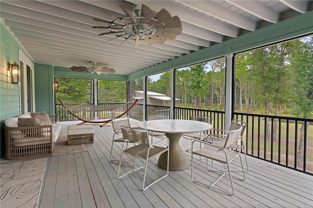 sunroom / solarium featuring beam ceiling and a wealth of natural light