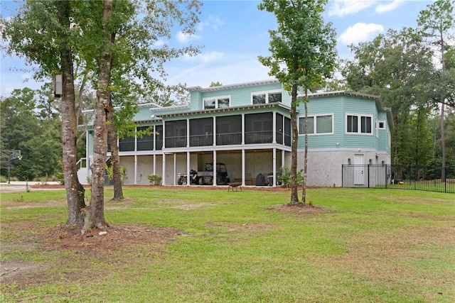 back of property with a yard and a sunroom