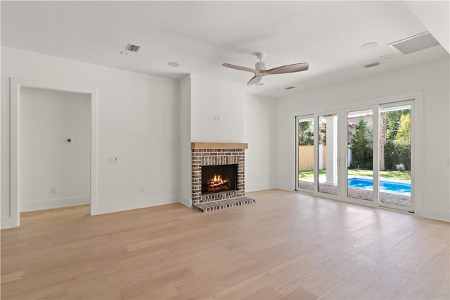 unfurnished living room with visible vents, a ceiling fan, light wood-style flooring, and baseboards
