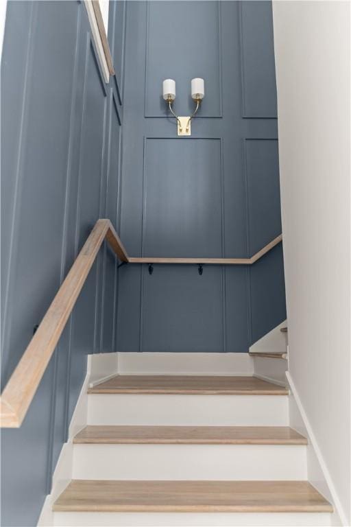 staircase with a decorative wall