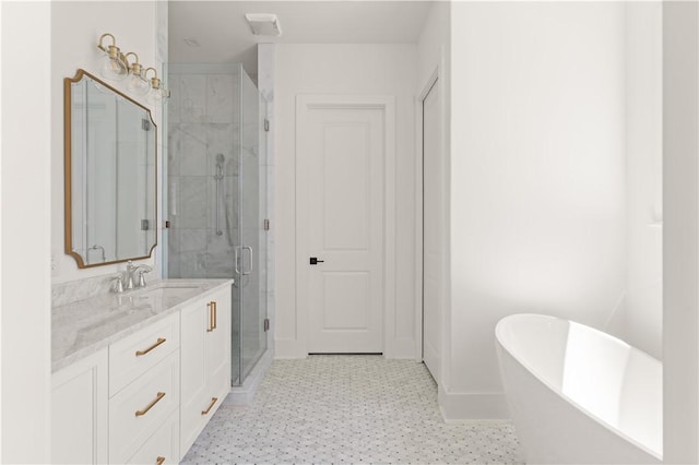 full bathroom featuring a stall shower, vanity, tile patterned floors, baseboards, and a soaking tub