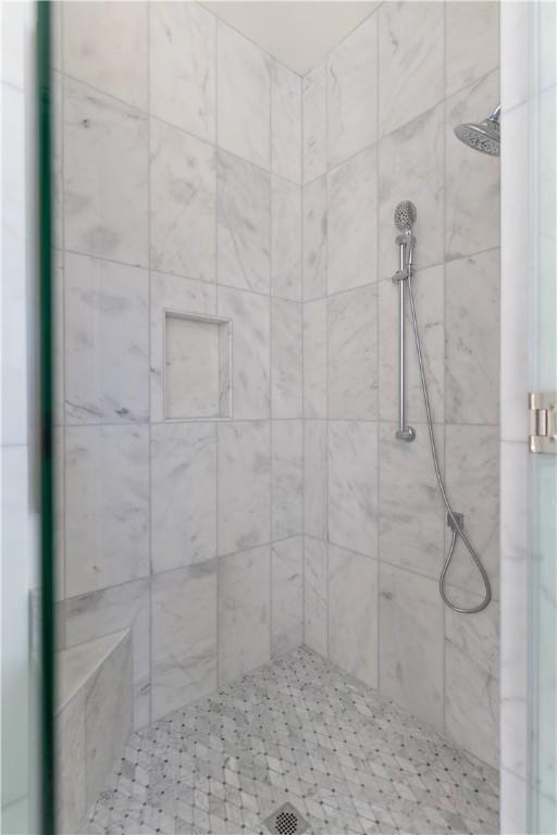 full bathroom with a tile shower
