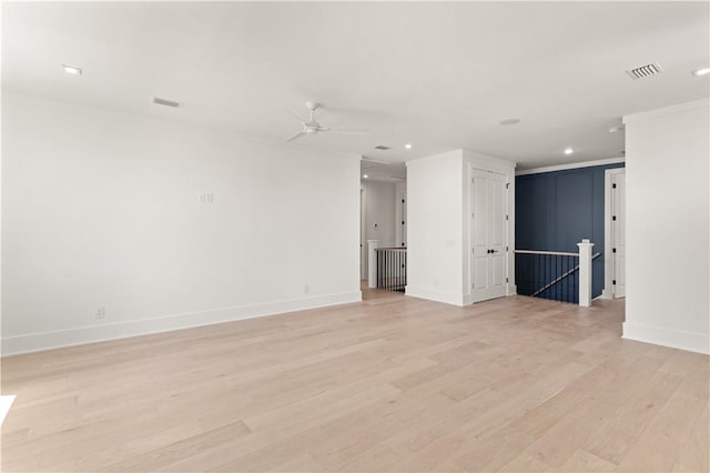 spare room featuring ceiling fan, visible vents, light wood-type flooring, baseboards, and recessed lighting
