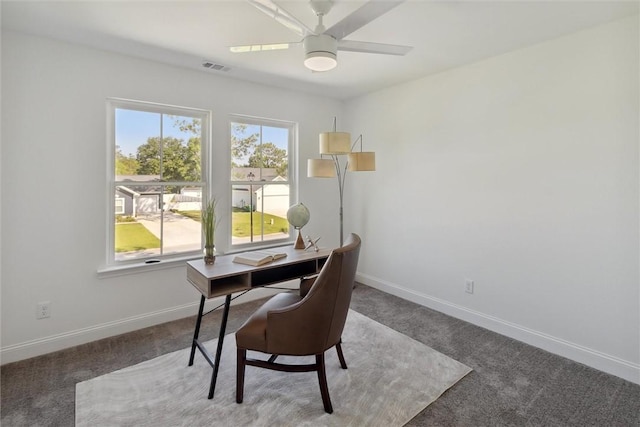 carpeted office space featuring ceiling fan