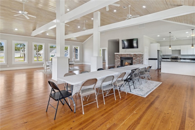 dining room with high vaulted ceiling, wood ceiling, and light wood-type flooring