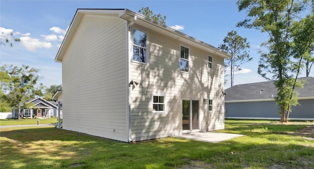 back of house with a lawn