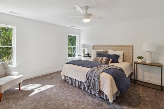 bedroom featuring dark carpet and ceiling fan