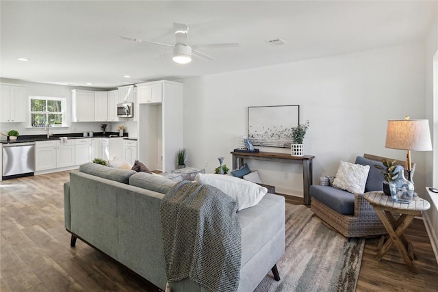 living room featuring dark hardwood / wood-style floors and ceiling fan