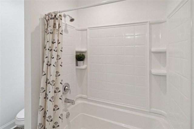 bathroom with shower / tub combo and toilet