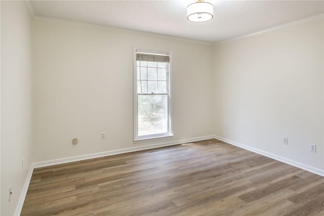 unfurnished room with a healthy amount of sunlight, a textured ceiling, crown molding, and dark hardwood / wood-style floors