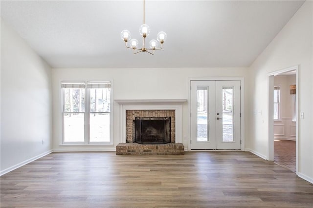 unfurnished living room with dark hardwood / wood-style floors, a wealth of natural light, and lofted ceiling