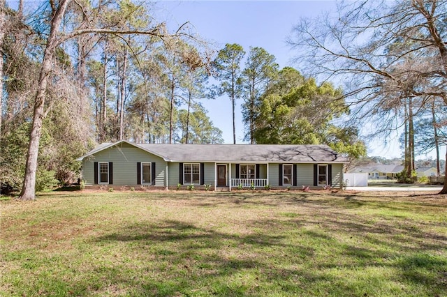 single story home featuring covered porch and a front yard