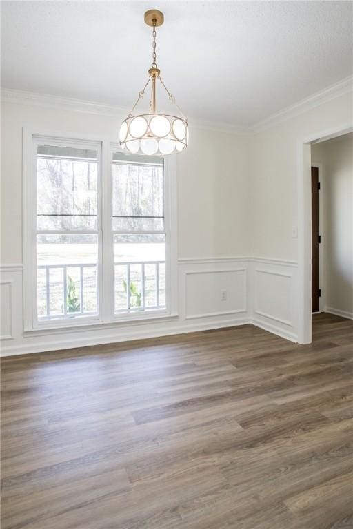 unfurnished dining area featuring plenty of natural light and crown molding