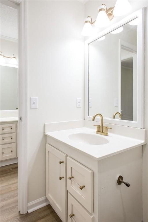 bathroom with hardwood / wood-style flooring and vanity