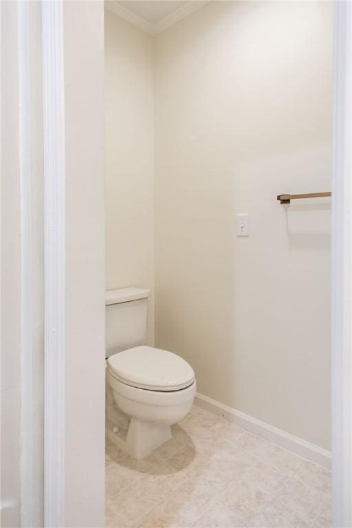 bathroom with crown molding, tile patterned flooring, and toilet