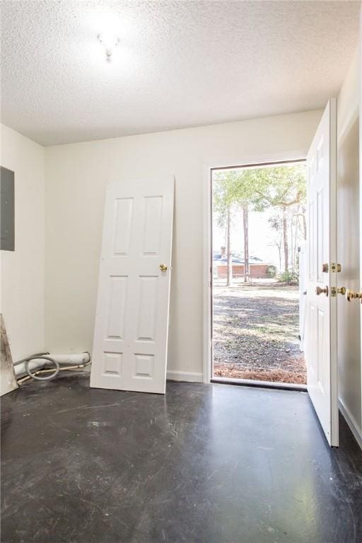 entrance foyer featuring electric panel and a textured ceiling