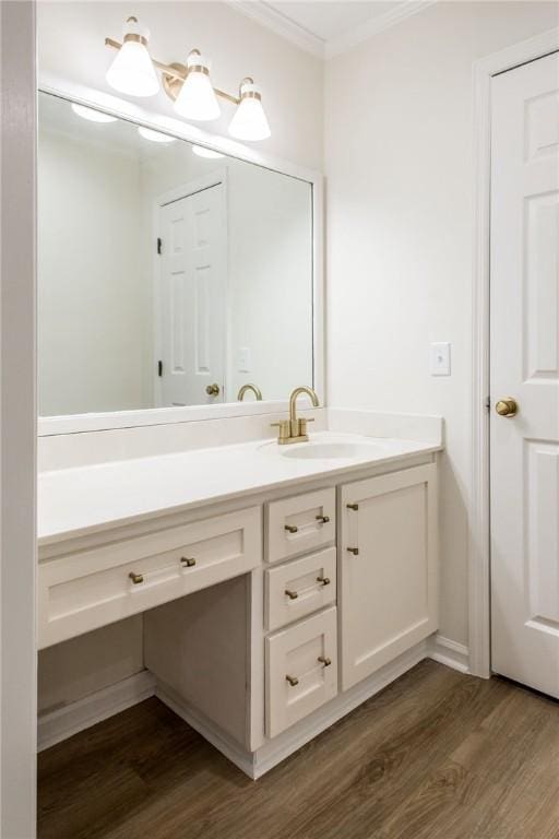 bathroom featuring vanity, crown molding, and wood-type flooring