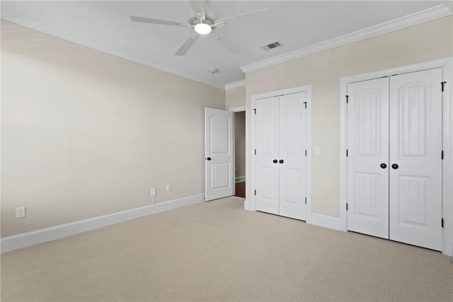 105 Gascoigne Ave Unit 204, Saint Simons Island, GA 31522 - unfurnished bedroom with ornamental molding, light colored carpet, multiple closets, and a ceiling fan