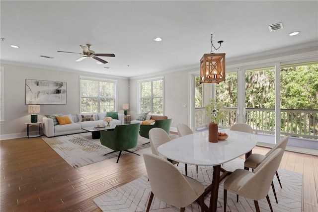 105 Gascoigne Ave Unit 204, Saint Simons Island, GA 31522 - dining area with ornamental molding, wood finished floors, ceiling fan, recessed lighting, and a chandelier