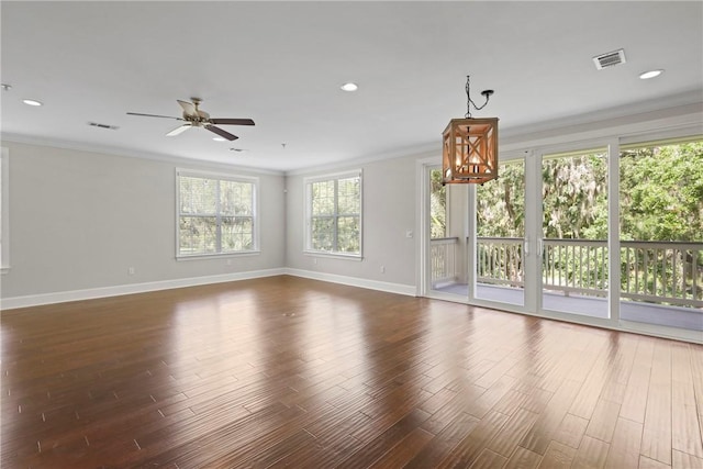 105 Gascoigne Ave Unit 204, Saint Simons Island, GA 31522 - unfurnished living room with ornamental molding, dark wood-type flooring, a ceiling fan, recessed lighting, and a chandelier