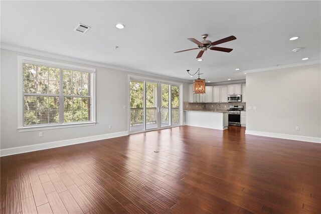 105 Gascoigne Ave Unit 204, Saint Simons Island, GA 31522 - unfurnished living room with crown molding, a ceiling fan, recessed lighting, and dark wood-type flooring