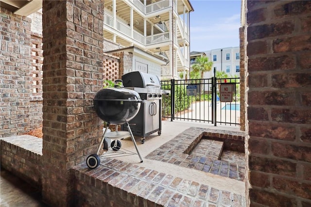 105 Gascoigne Ave Unit 204, Saint Simons Island, GA 31522 - view of patio / terrace with a grill and a gate
