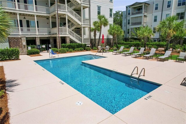 105 Gascoigne Ave Unit 204, Saint Simons Island, GA 31522 - community pool with a patio area and stairway