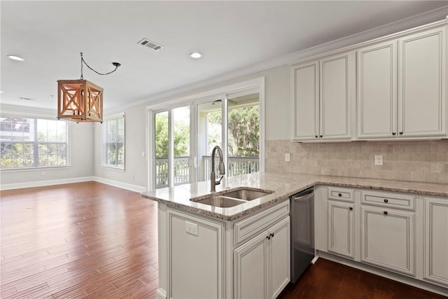 105 Gascoigne Ave Unit 204, Saint Simons Island, GA 31522 - kitchen with stainless steel dishwasher, dark wood-style floors, decorative backsplash, ornamental molding, and a chandelier