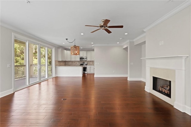 105 Gascoigne Ave Unit 204, Saint Simons Island, GA 31522 - unfurnished living room featuring a ceiling fan, a fireplace, ornamental molding, dark wood-type flooring, and recessed lighting