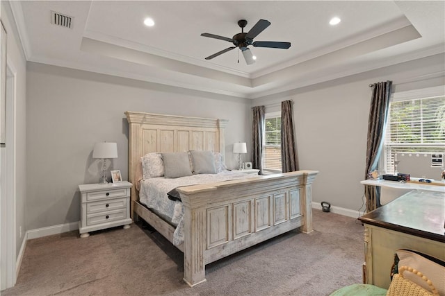 bedroom featuring carpet, ceiling fan, a raised ceiling, and crown molding