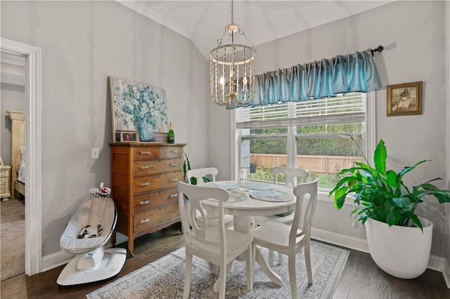 dining area with dark hardwood / wood-style floors, an inviting chandelier, and lofted ceiling