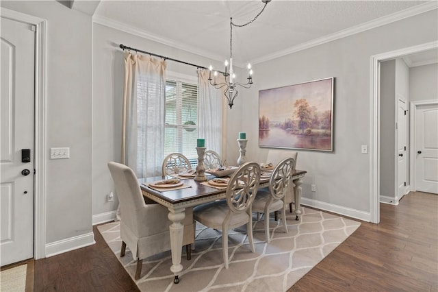 dining room featuring a notable chandelier, wood-type flooring, and crown molding