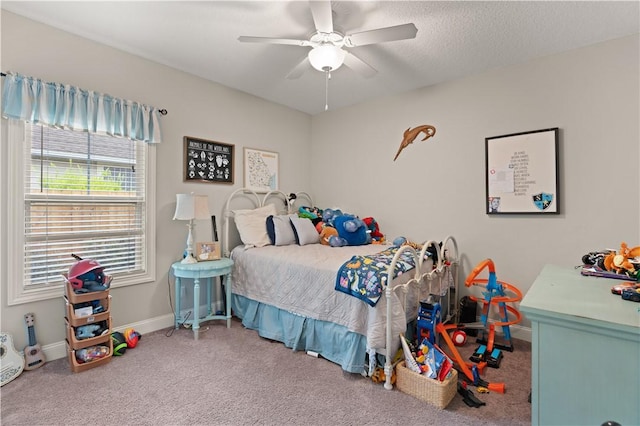 bedroom with a textured ceiling, carpet floors, and ceiling fan