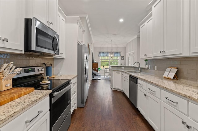 kitchen with white cabinets, sink, hanging light fixtures, dark hardwood / wood-style flooring, and stainless steel appliances