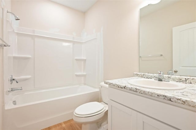 full bath with toilet, tub / shower combination, wood finished floors, and vanity