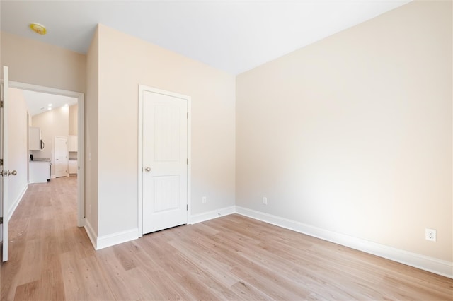 unfurnished bedroom with light wood-style floors and baseboards