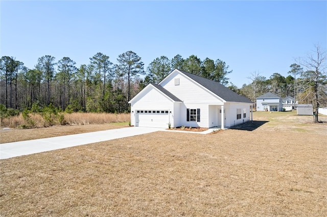 view of front of home with an attached garage, a front lawn, and concrete driveway