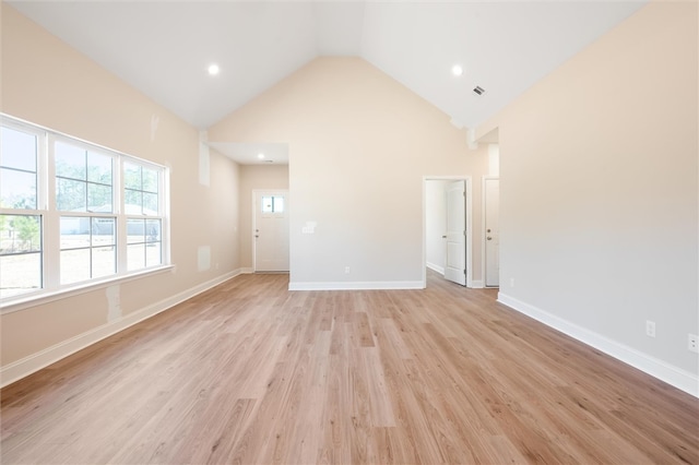 unfurnished living room with high vaulted ceiling, light wood finished floors, recessed lighting, and baseboards