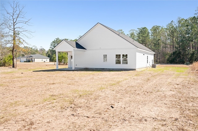 back of house with central AC unit