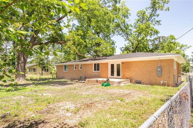 201 Washington Ave, Waycross, GA 31503 - rear view of house with french doors, brick siding, a fenced backyard, and central air condition unit