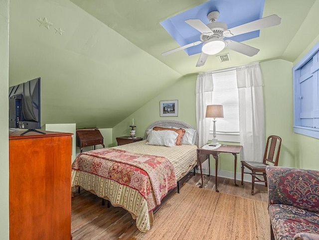 bedroom featuring hardwood / wood-style floors, vaulted ceiling, and ceiling fan