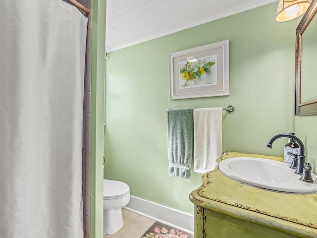 bathroom with tile patterned flooring, crown molding, vanity, and toilet