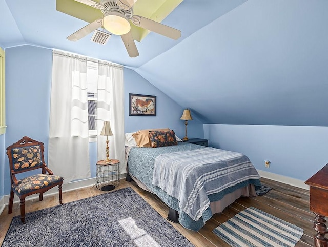 bedroom featuring vaulted ceiling, dark hardwood / wood-style floors, and ceiling fan