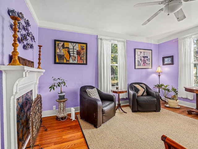 sitting room featuring wood-type flooring, a wealth of natural light, and ceiling fan