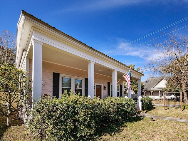 view of side of home featuring covered porch