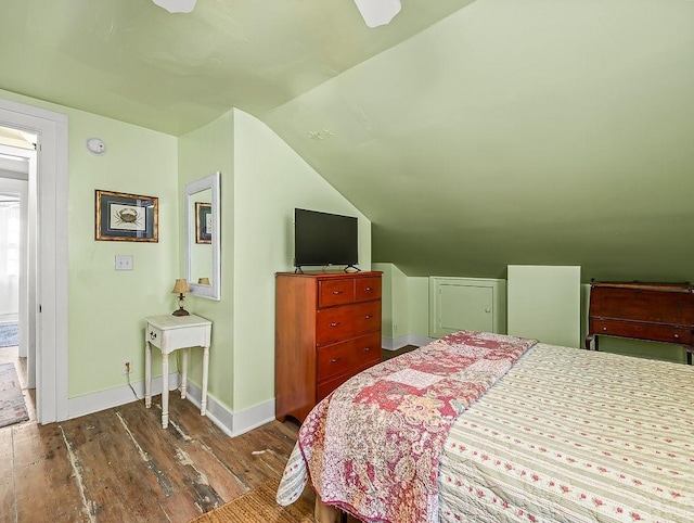 bedroom with lofted ceiling and dark hardwood / wood-style flooring