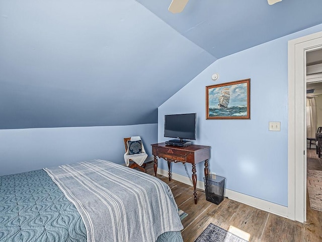 bedroom featuring ceiling fan, lofted ceiling, and hardwood / wood-style floors